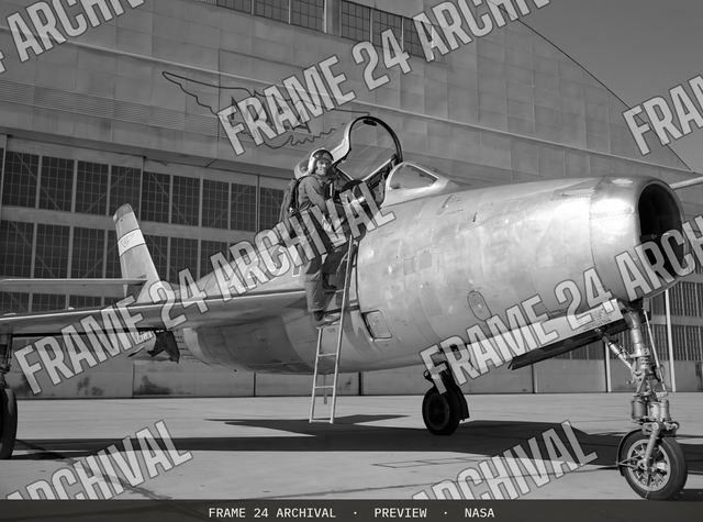 Ames Pilot George Cooper and F-84F airplane on ramp, vintage black and white photograph