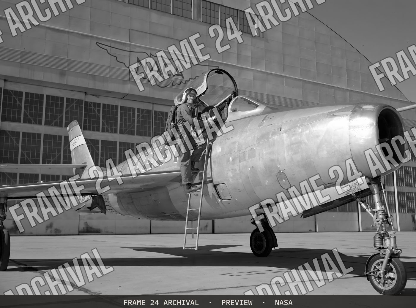 Ames Pilot George Cooper and F-84F airplane on ramp (1955), restored vintage black and white photograph