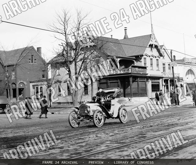 Automobile on town street, vintage black and white photograph