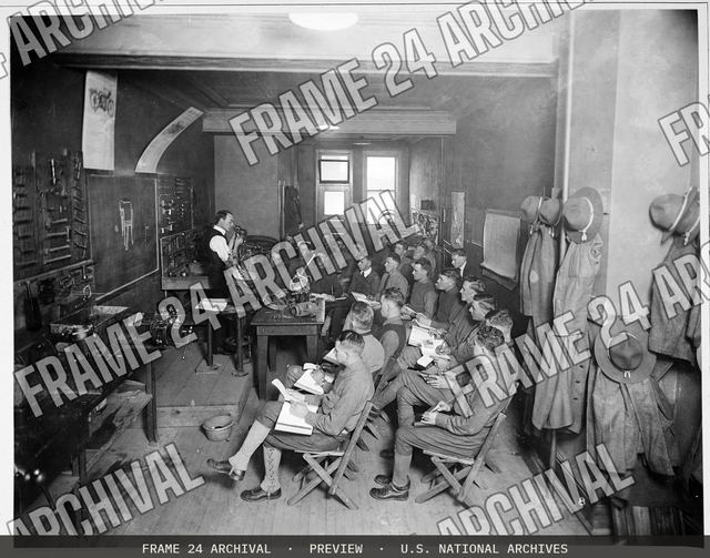 Colleges and Universities - Harley Davidson School for Motorcycle Mechanics - Instruction on the parts of the motorcycle at school for motorcycle mechanics, vintage black and white photograph