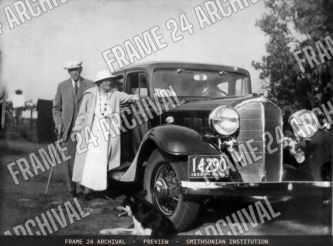 Couple with Car and Dog (1935), restored vintage black and white photograph