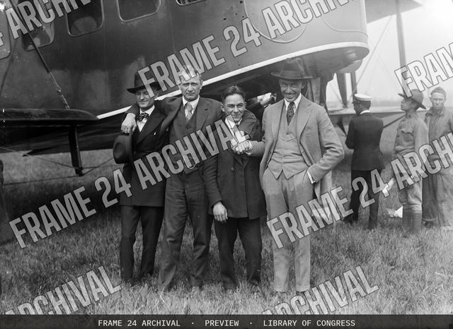 Group at airplane, vintage black and white photograph