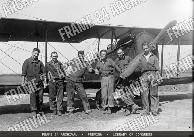 Group at airplane, vintage black and white photograph