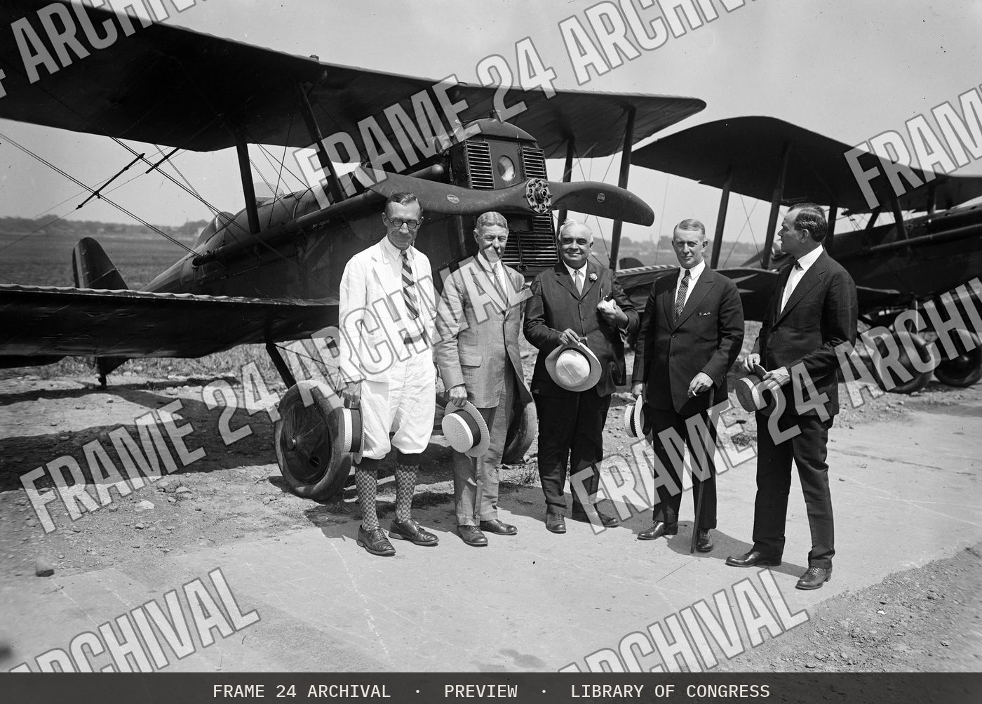 Group at airplane (1924), restored vintage black and white photograph