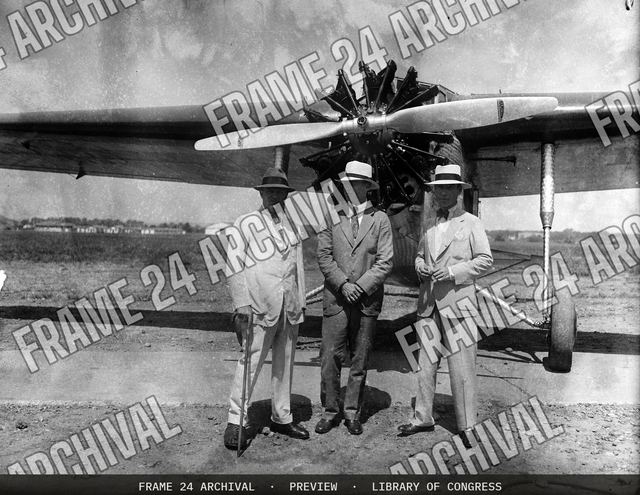 Group at airplane, vintage black and white photograph