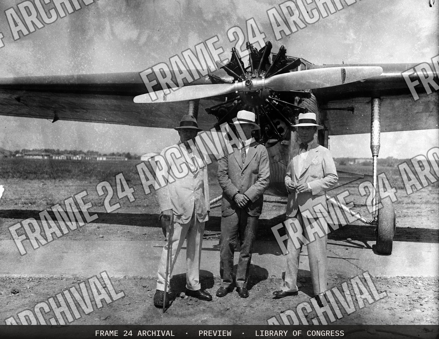 Group at airplane (1929), restored vintage black and white photograph