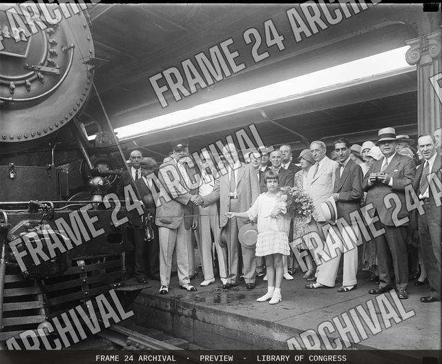 Group at train station, vintage black and white photograph