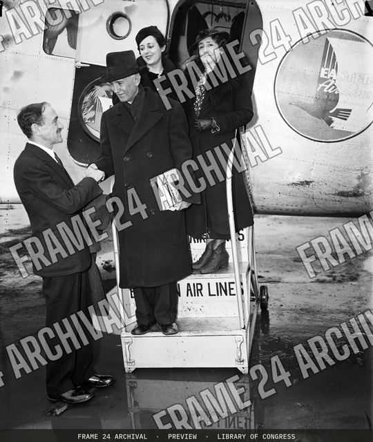 Group exiting airplane, vintage black and white photograph