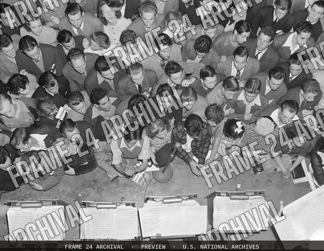 Oakland, California. Hot Jazz Recreation. Swing enthusiasts crowd against the band stand at an appearance of the Benny Googman Band in a local dance hall. One of the boys in the foreground has a copy, vintage black and white photograph