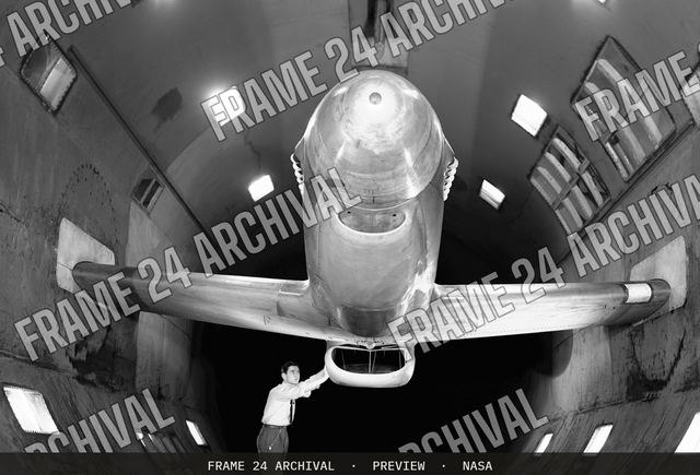 XP-51B airplane in 16ft wind tunnel with test engineer, vintage black and white photograph